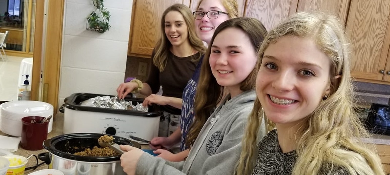 Young people preparing food together at church